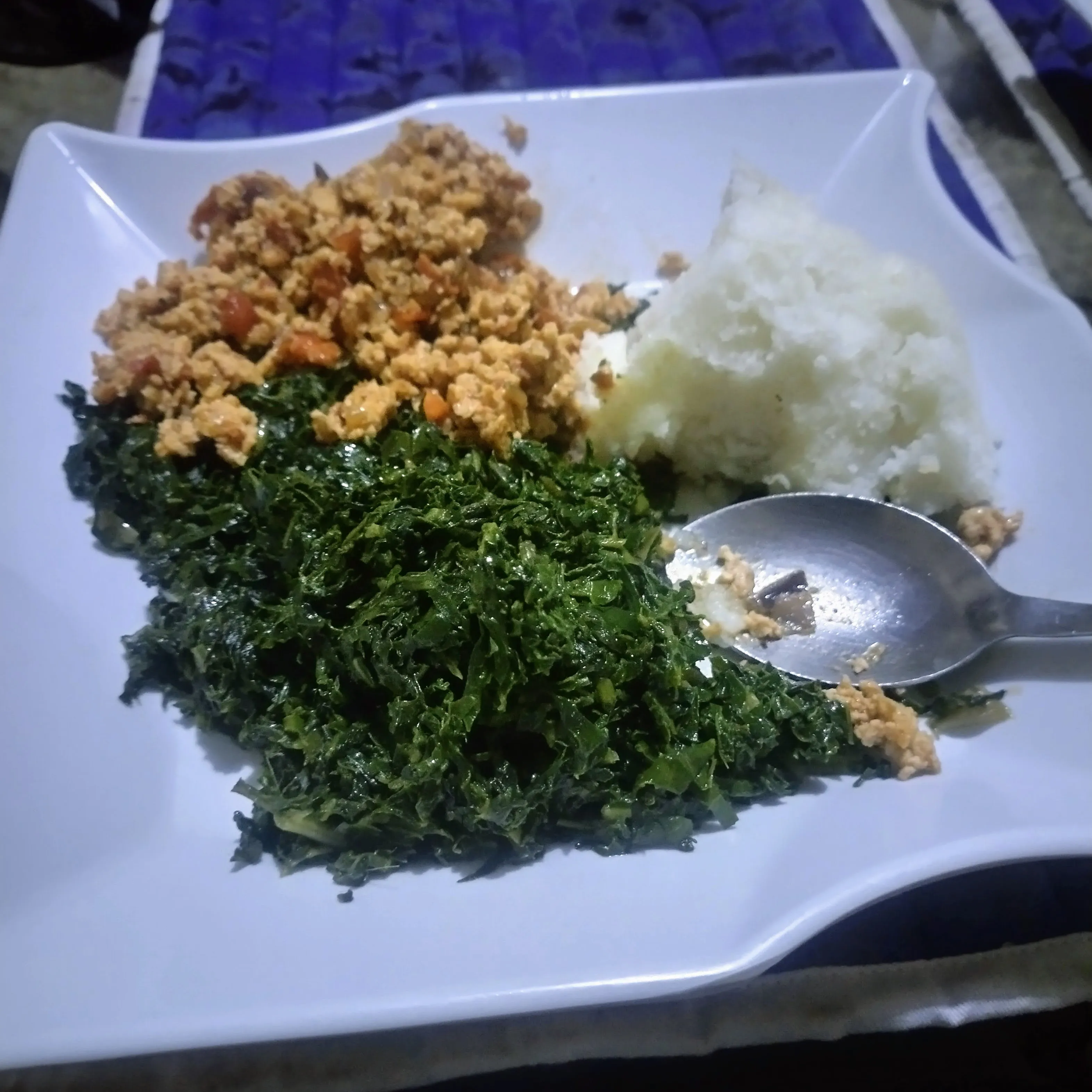Plate of eggs with sukuma wiki and ugali