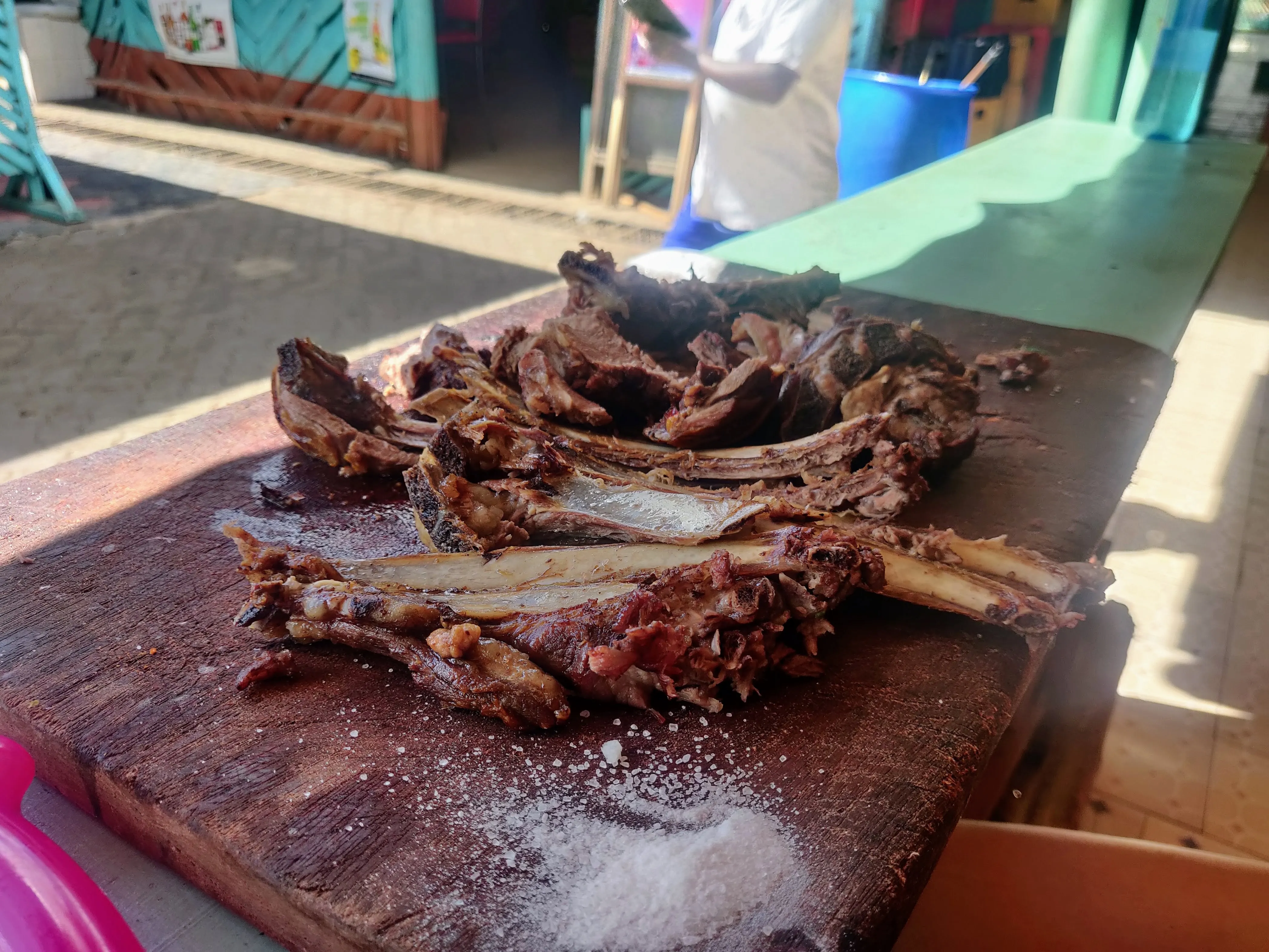 Nyama choma goat ribs on a wooden board