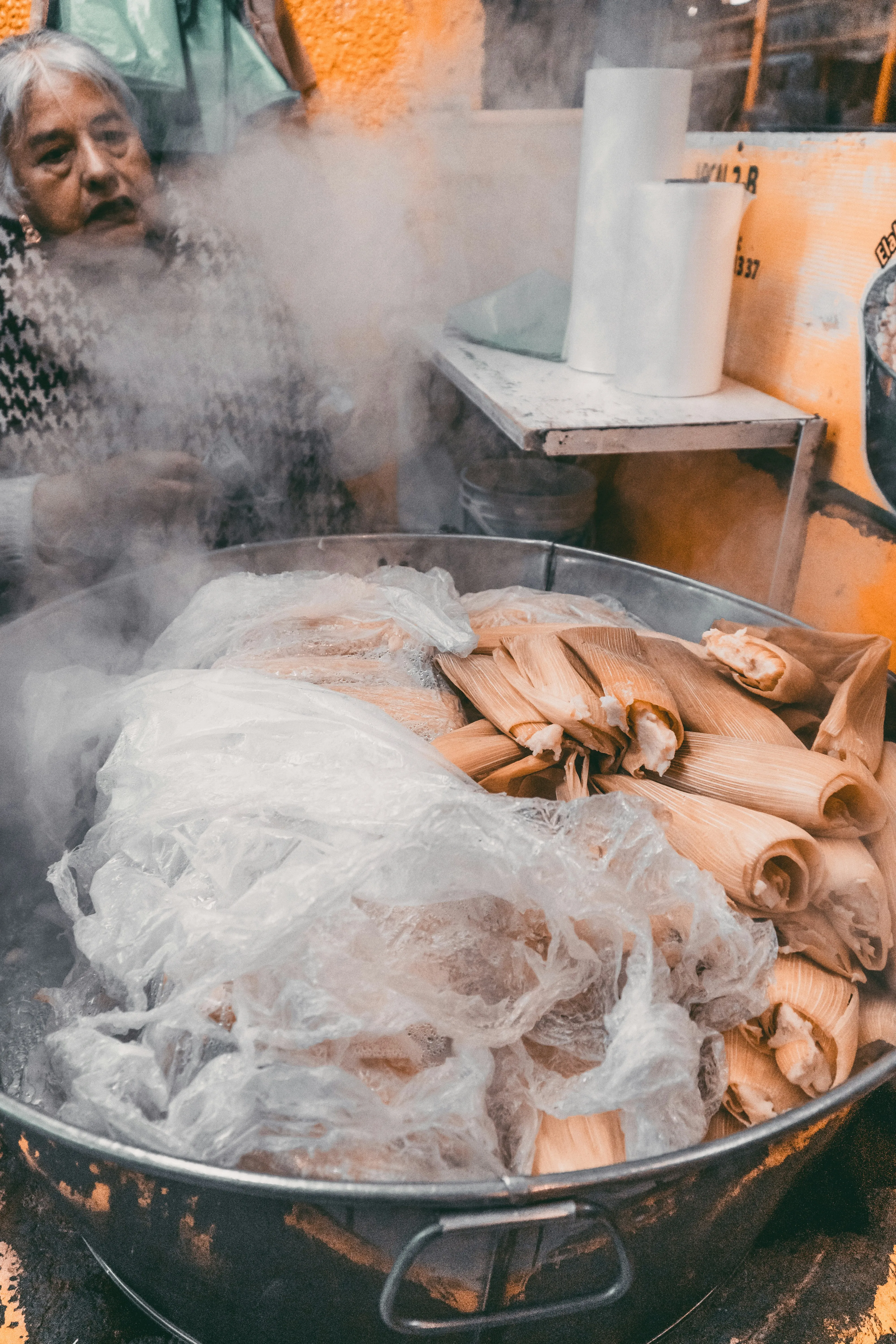 Tamales steaming in a pan