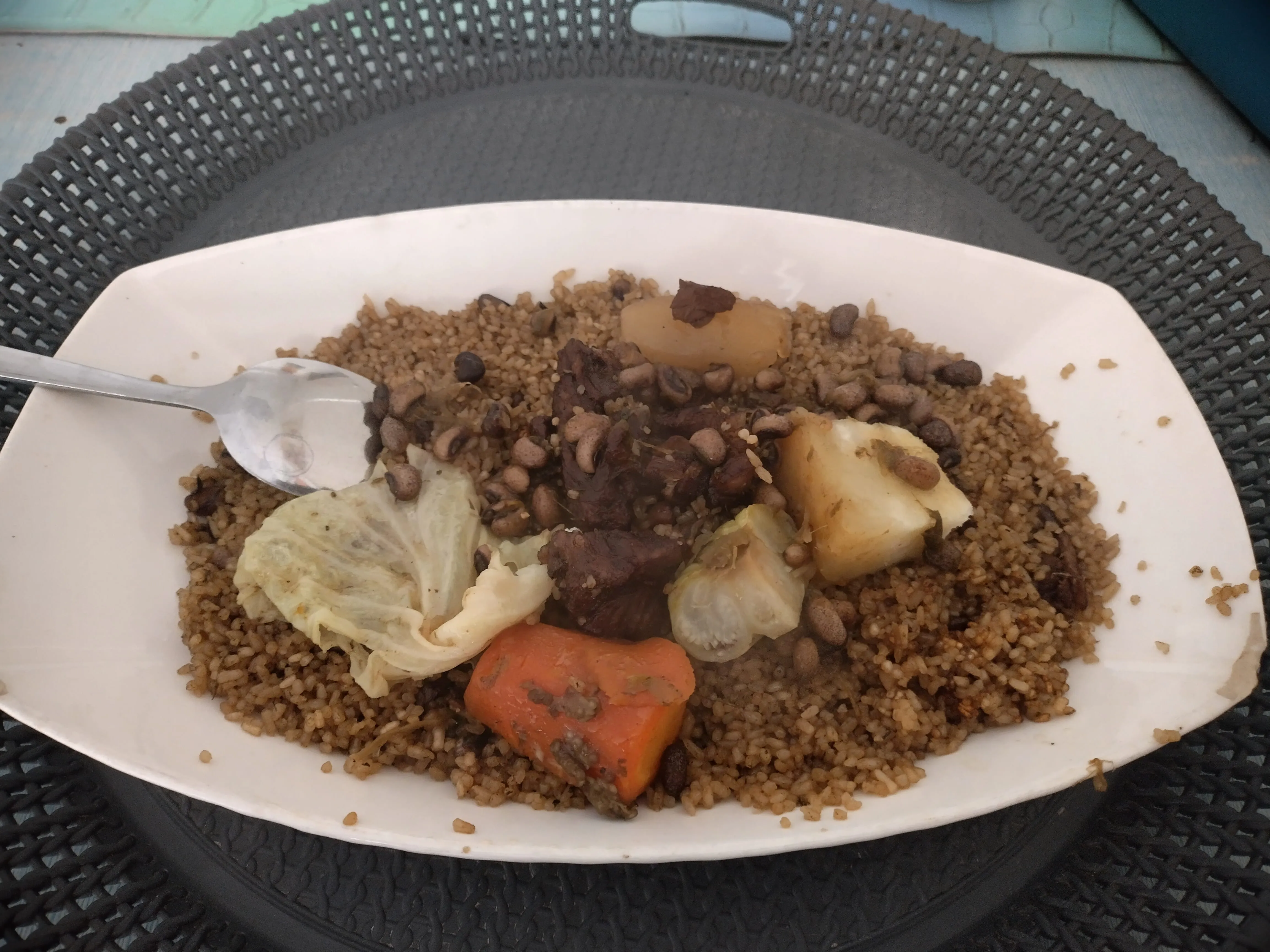 A plate of thieboudienne — rice with fish and vegetables