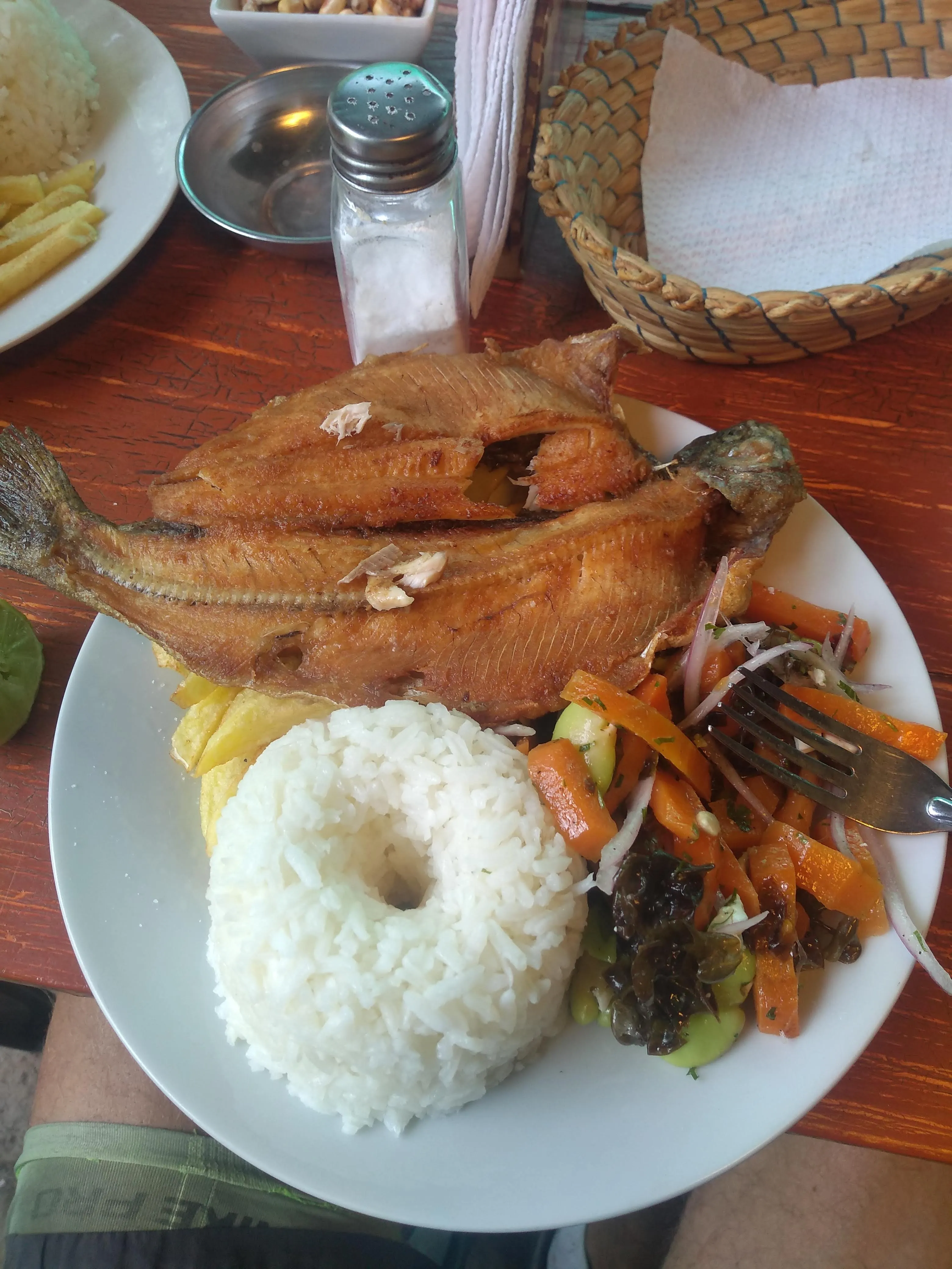 Grilled trout with rice and potatoes at a Peruvian lunch restaurant