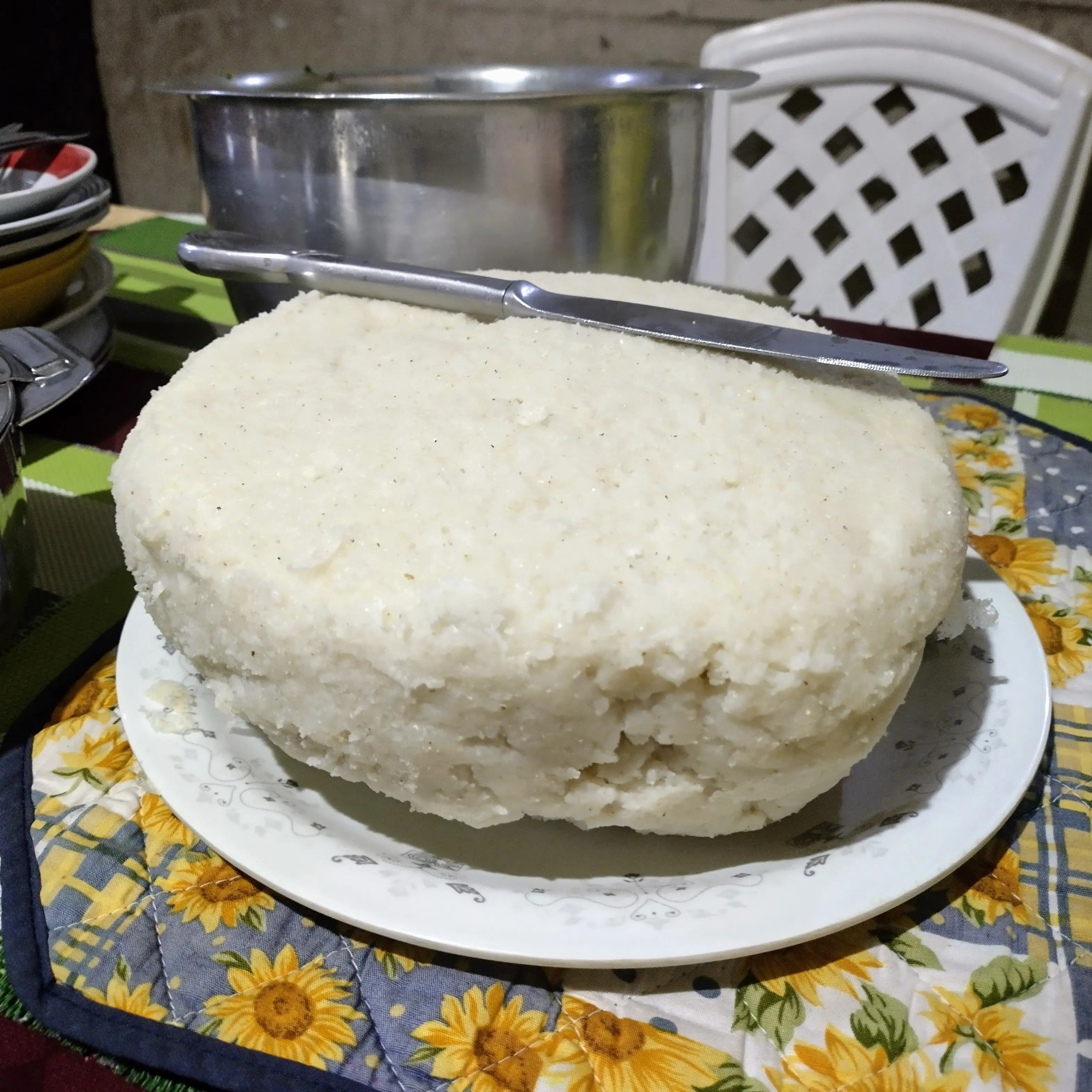 A large dome of ugali served on a plate